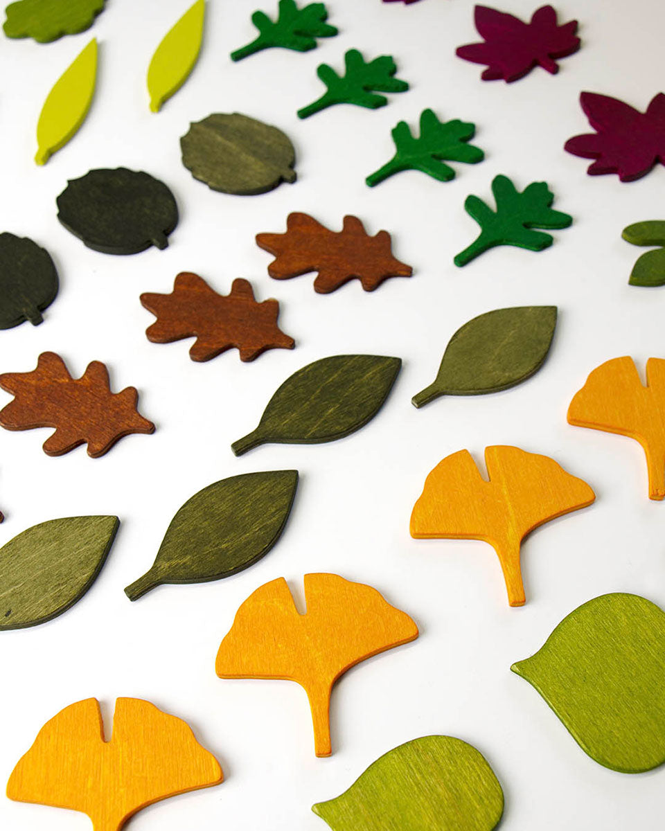 Moon Picnic eco-friendly wooden leaves laid out in rows on a white background