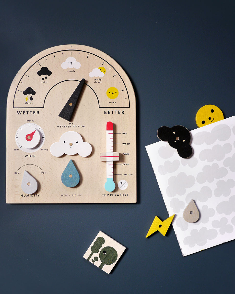 Plastic free wooden weather station toy on a dark grey background