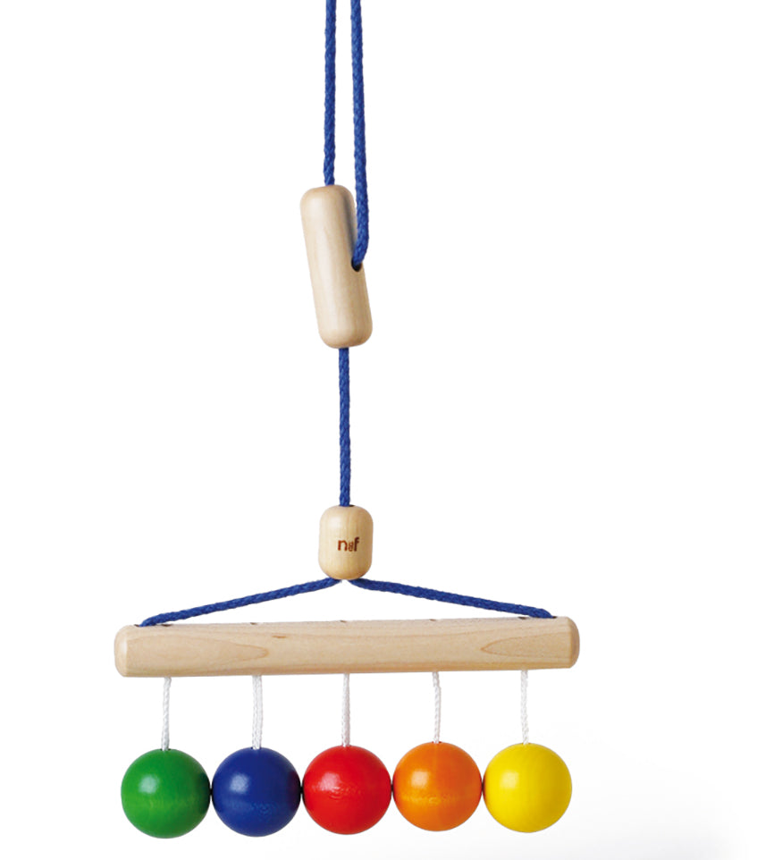 Naef's Colour Balls wooden baby rattle hanging from its string on a white background.