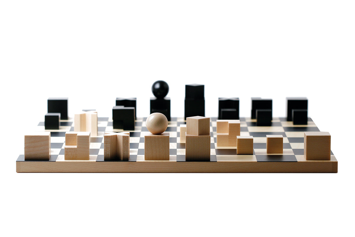 Naef premium wooden chess pieces on the Naef Bauhaus chess board on a white background