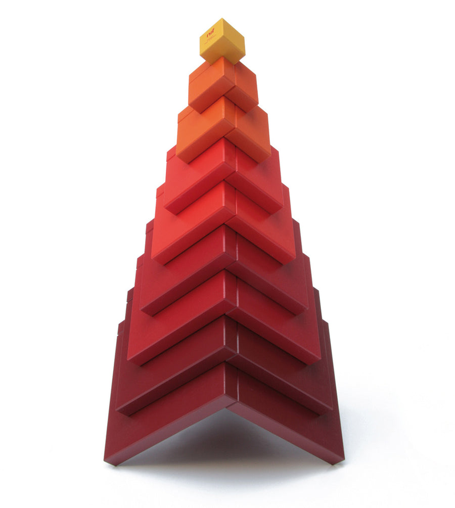 Naef's Cella cube toy stacked in a pyramid shape on a white background.