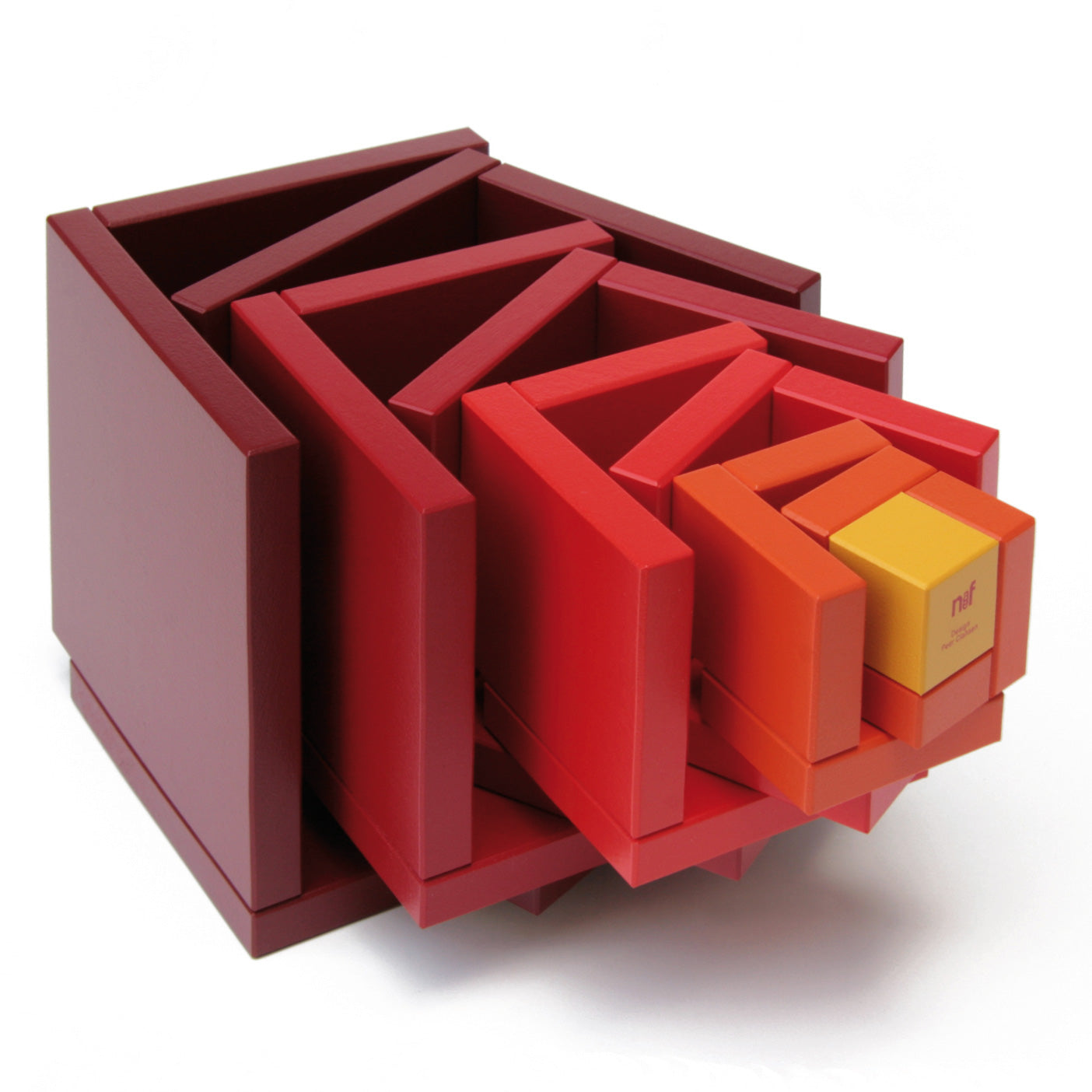 Naef Cella Stacking Cube in a red colour shown with pieces pulled apart pictured on a plain background