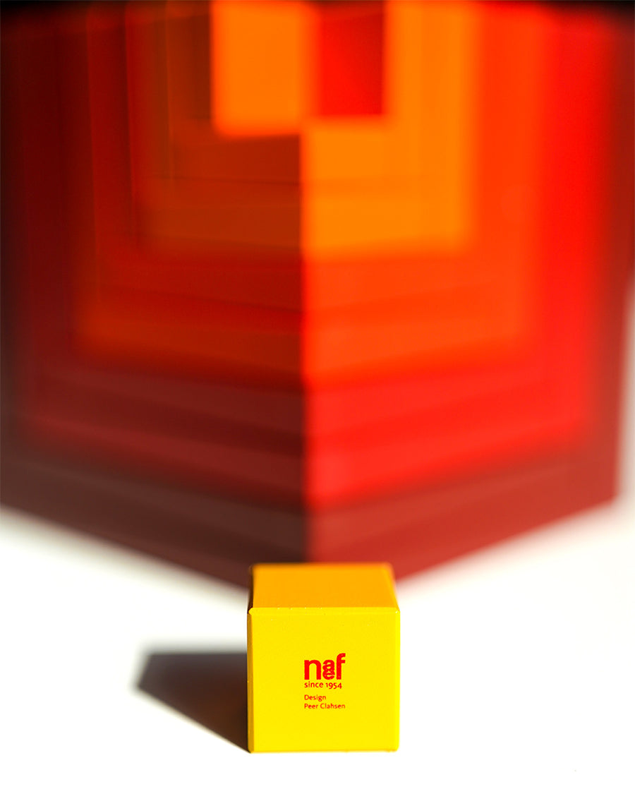 Naef Cella Cubes stacked corner to corner on top of each other on a white background.