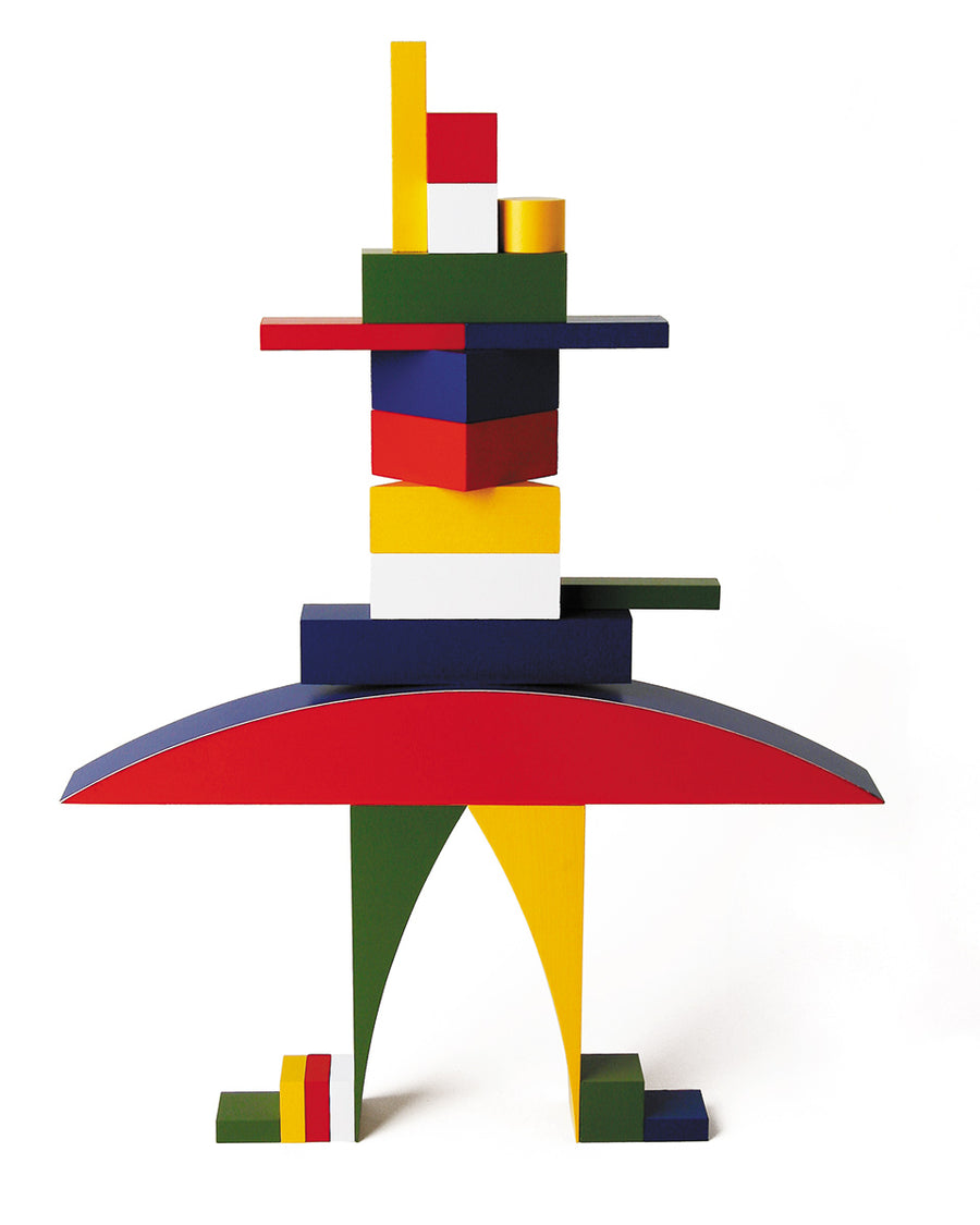 Naef Bauhaus building blocks stacked into a person shape on a white background