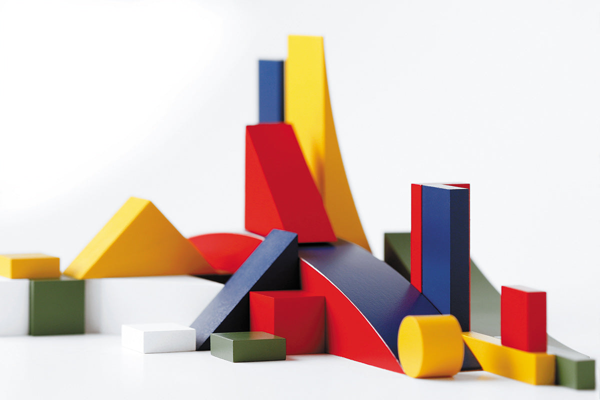 Close up of the Naef multicoloured wooden building toys on a white background