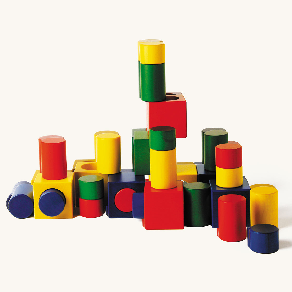 Naef Ligno coloured toy blocks set laid out in a train shape on a beige background