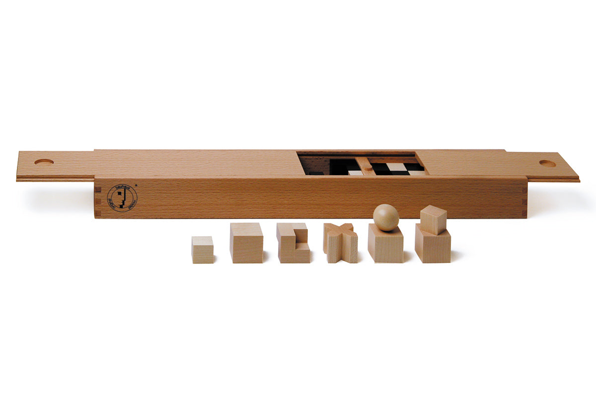 Pieces from the Naef eco-friendly wooden chess pieces set in front of their wooden storage box on a white background