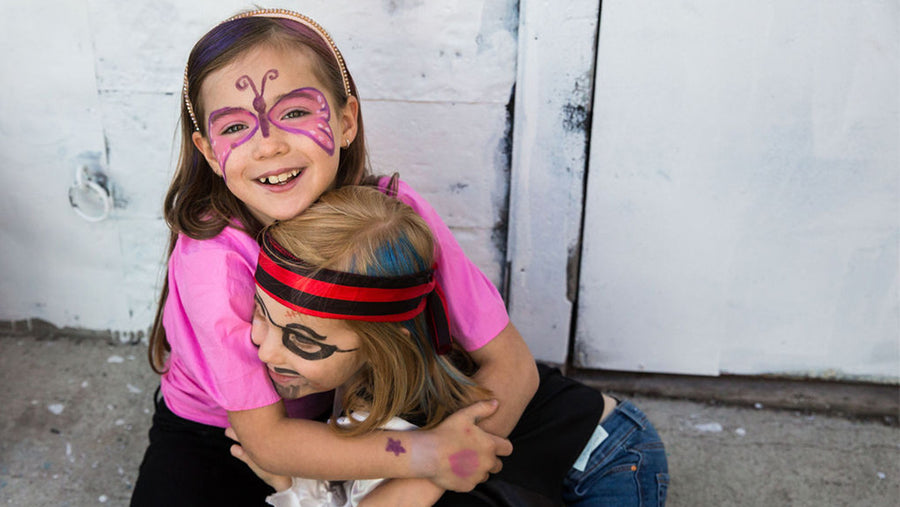 Two kids hugging and wearing Namaki organic face paint