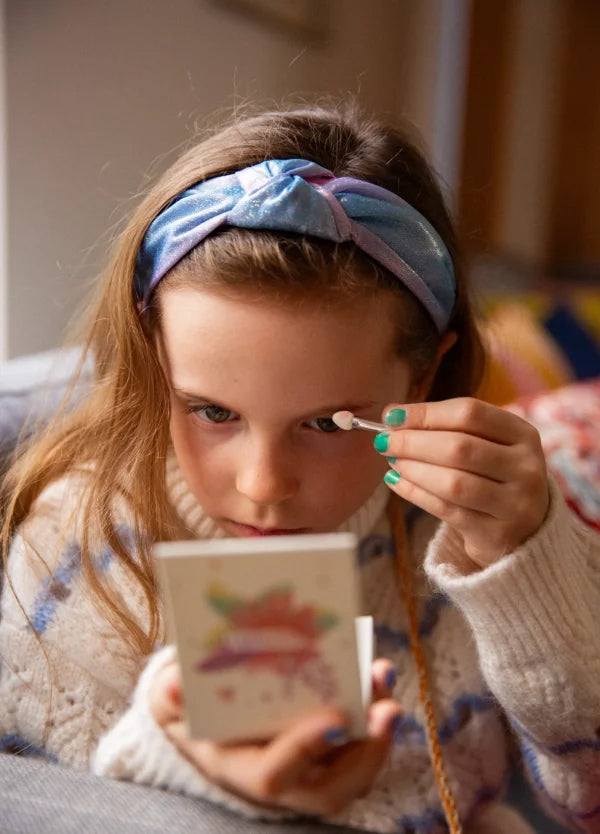 A child applying the Namaki Natural Eyeshadows Palette - Spring