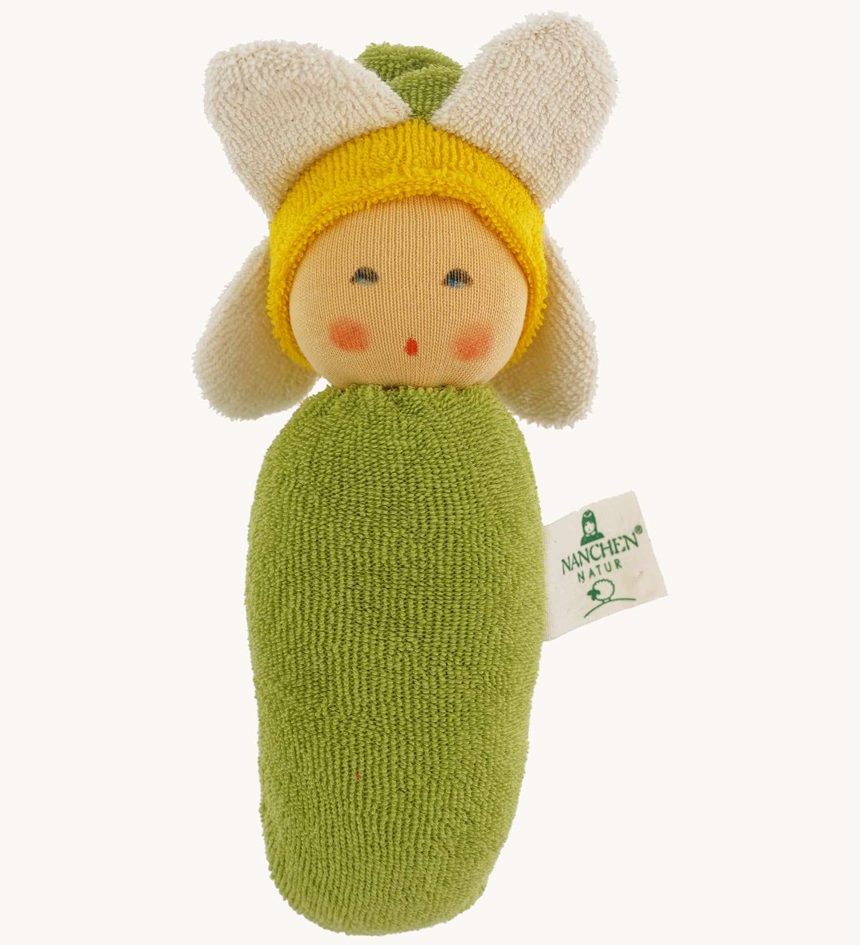 Nanchen Flower Rattle Doll - Daisy, is a soft, organic and handmade sensory doll toy with a green body, a little greet hat with white daisy leaves and a yellow strip of fabric to mimic hair. This doll also has an adorable face with green eyes