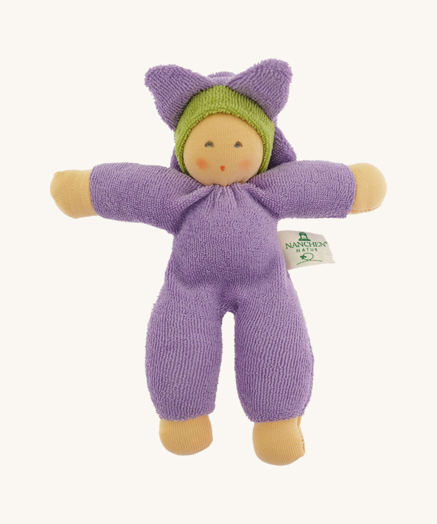 The Nanchen Flower Fairy Rattle Doll as a soft lilac terry material body, with a pretty lilac terry material hat in the shape of a flower, and a green terry strip of fabric just under the hat