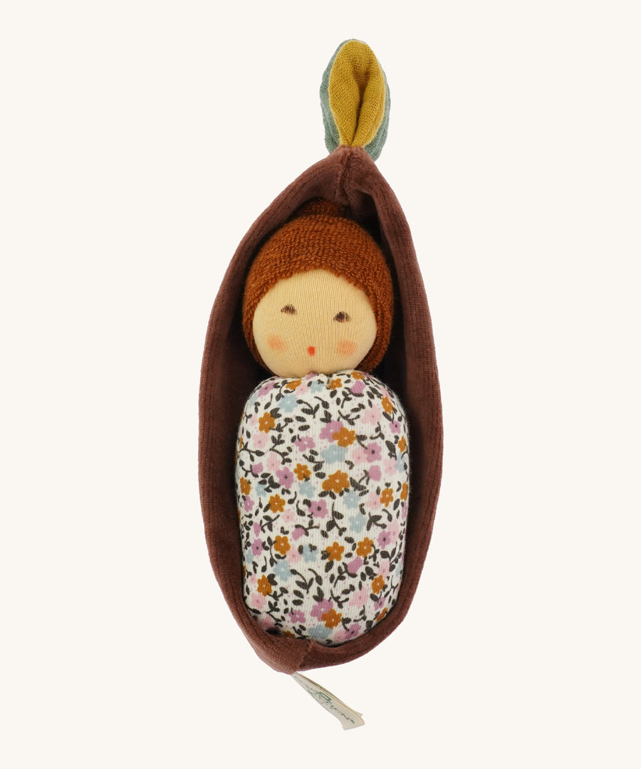 Nanchen Oak Baby Waldorf Doll - Floral. A little organic grasping doll in a brown velvet cradle on a cream background.