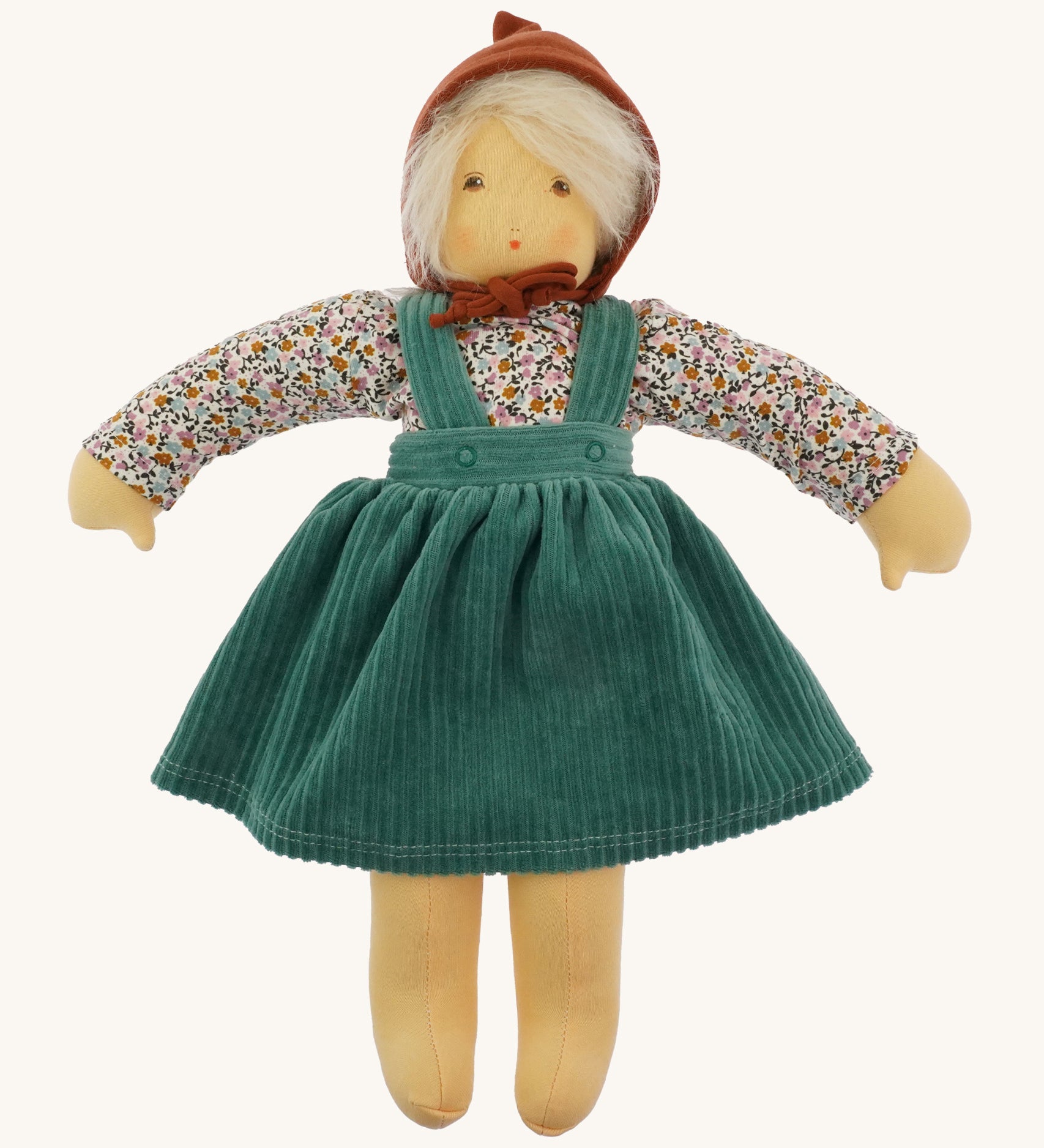 Nanchen Waldorf Doll - Lotte, an organic doll wearing a floral blouse, green cord pinafore dress and a brown bonnet. 