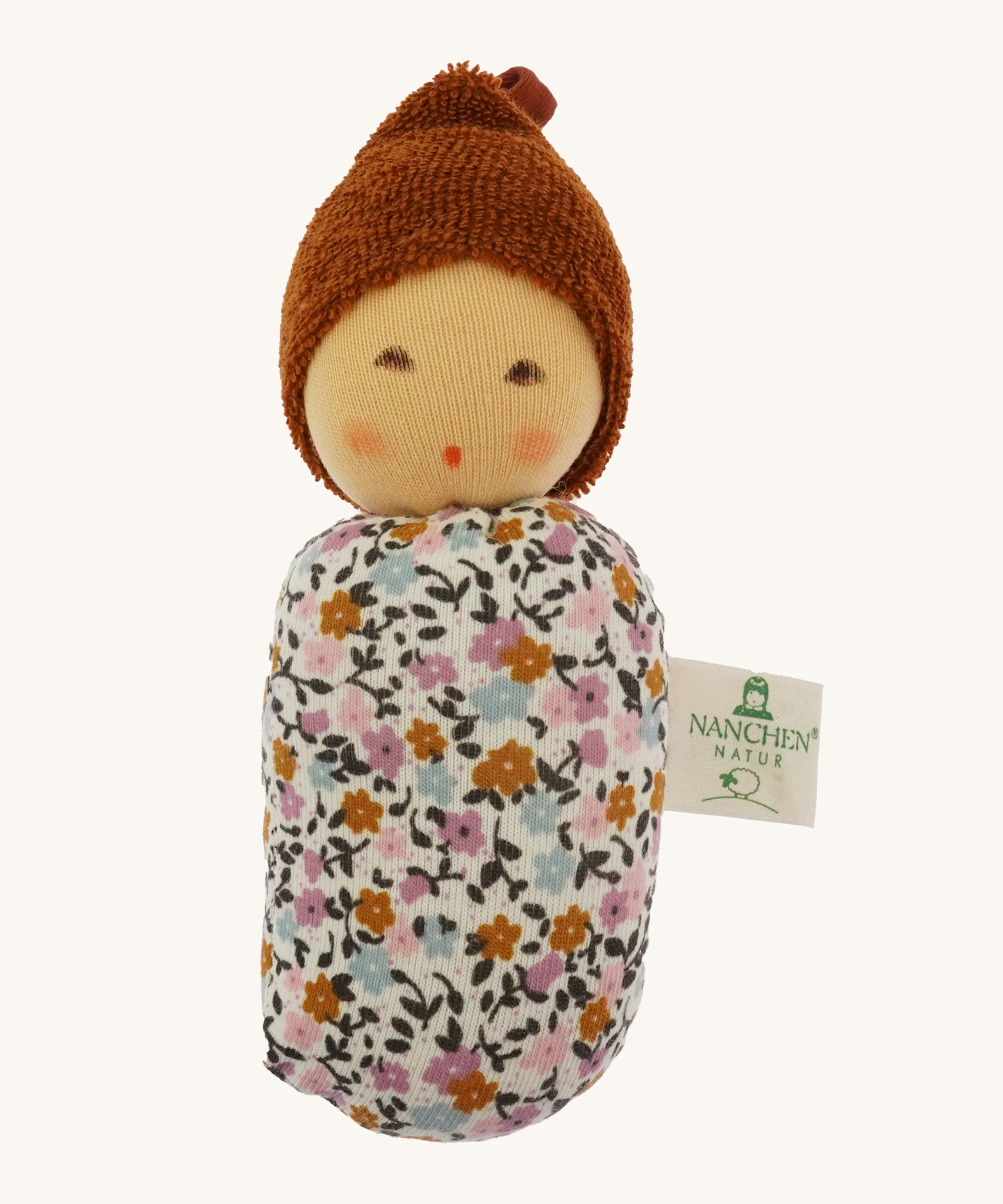 Nanchen Oak Baby Waldorf Doll - Floral. A little organic grasping doll in a floral swaddle on a cream background.