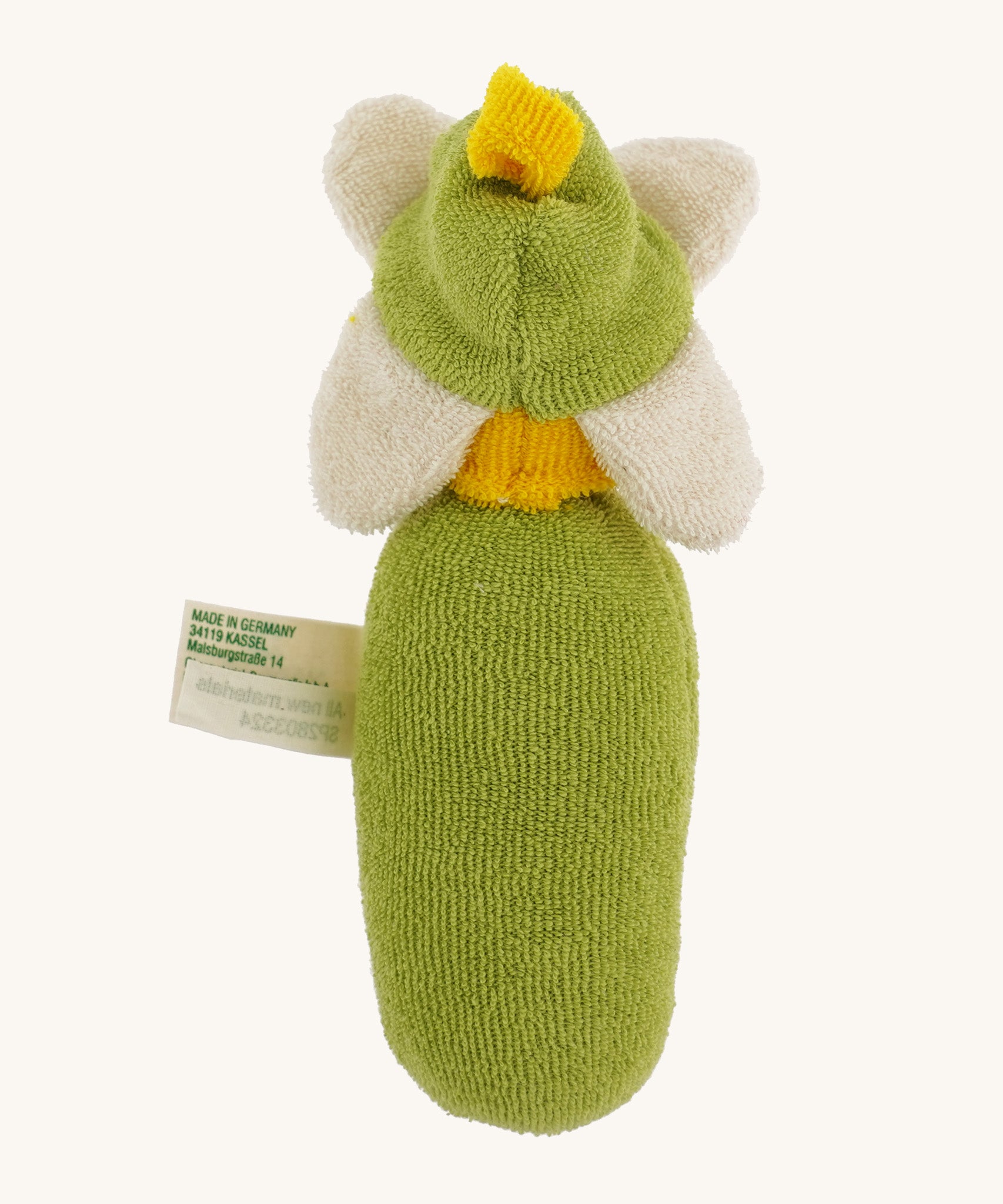 The back of the Nanchen Flower Rattle Doll - Daisy, is a soft, organic and handmade sensory doll toy with a green body, a little greet hat with white daisy leaves and a yellow strip of fabric to mimic hair. 