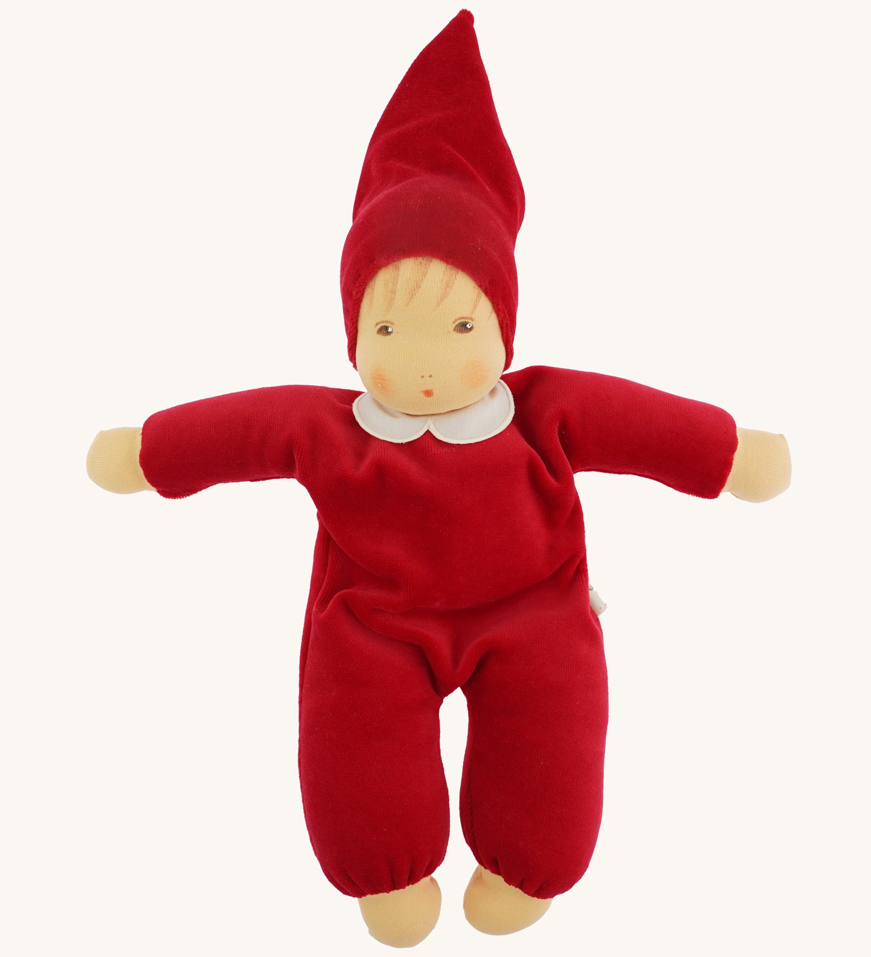 A beautiful Nanchen Waldorf Nani Doll, with a pretty hand painted face. This hand crafted doll toy has a red fabric, soft body with a small white collar and red pointy hat. On a cream background