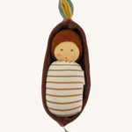 Nanchen Oak Baby Waldorf Doll - Stripes. A little organic grasping doll in a brown velvet cradle on a cream background.