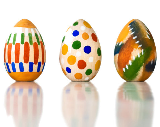 Image of three wooden eggs from the kit painted pictured on a plain white background