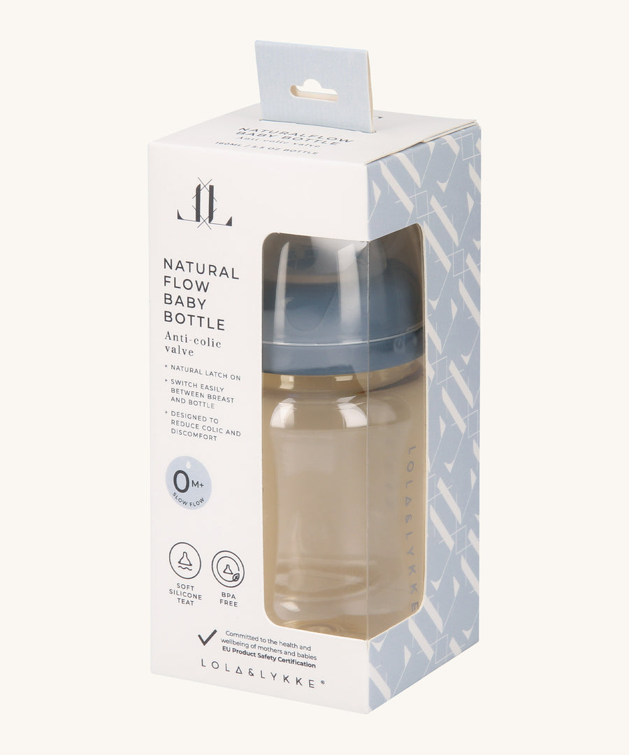 The Lola & Lykke Natural Flow Baby Bottle with cap, inside it's packaging. The packaging has a cut out so you can see the bottle inside