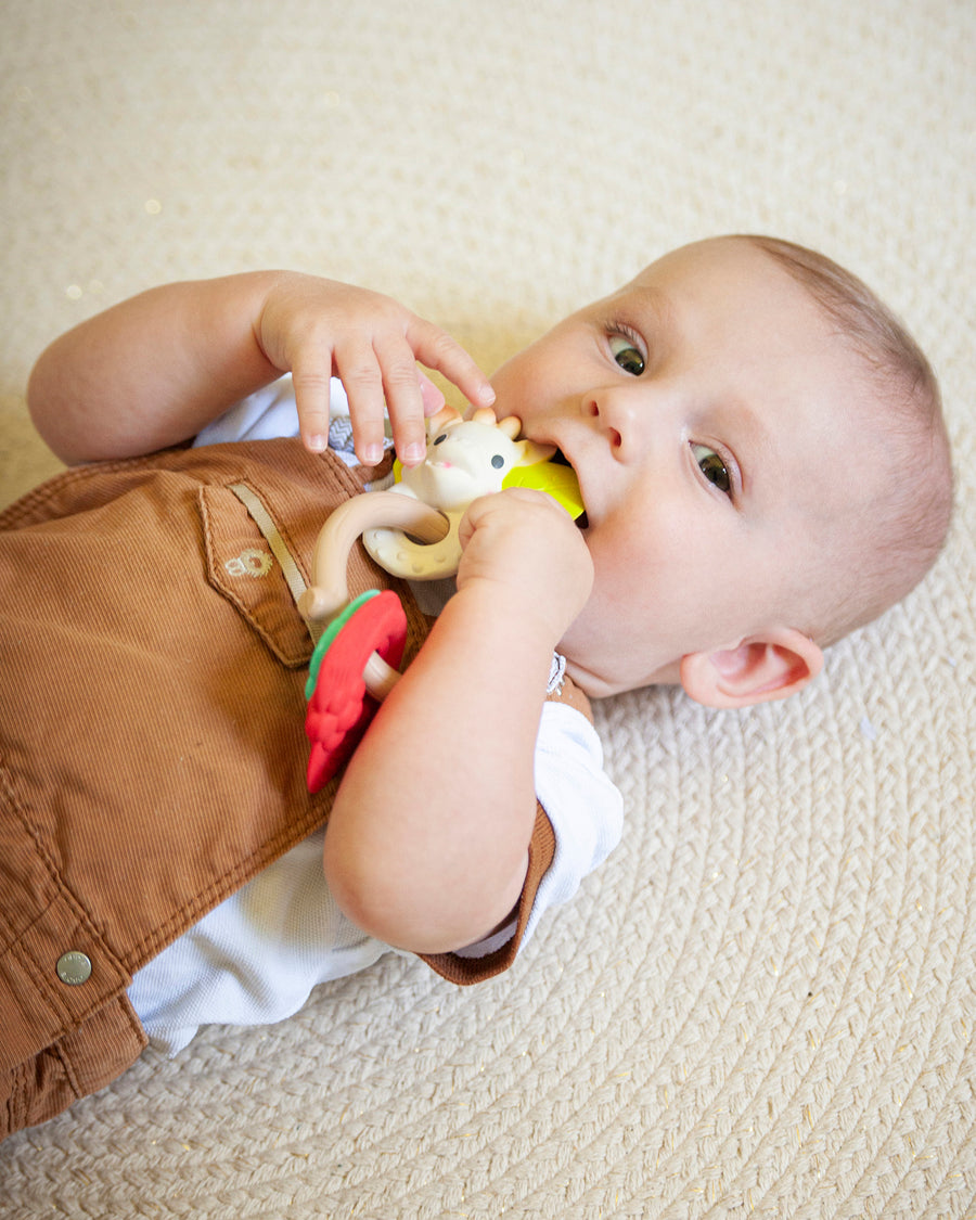 A child laid down on a cream rug