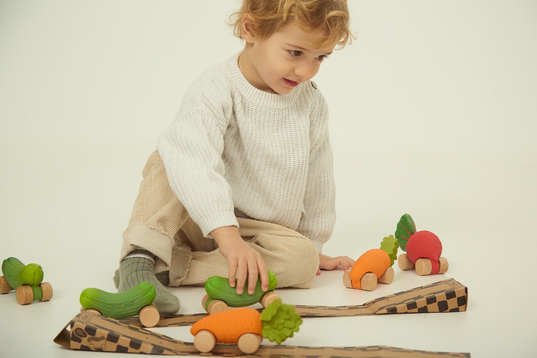 A child playing with the Oli Carol Rubber Cars