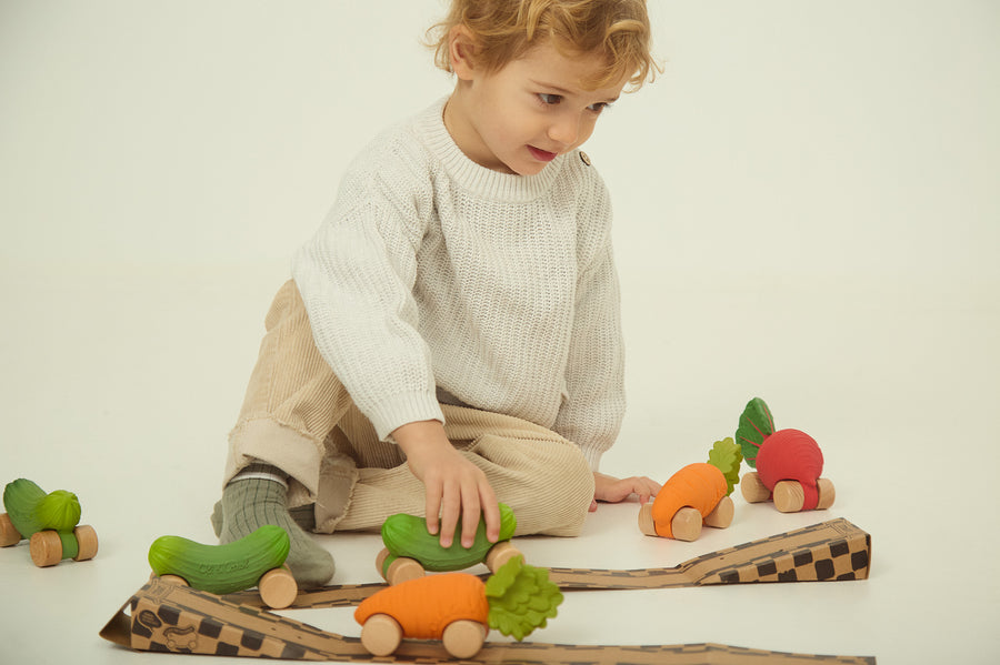 A child playing with the Oli Carol Rubber Cars