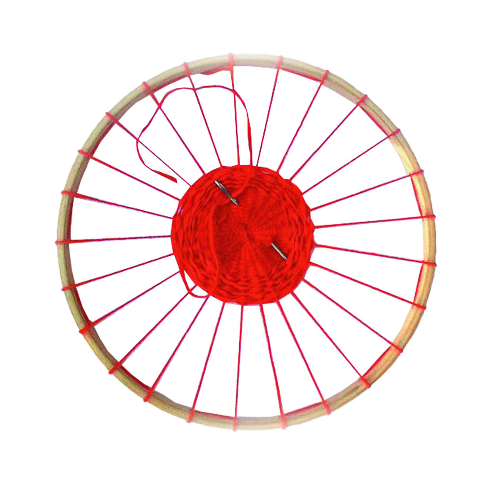 Nic eco-friendly weaving circle craft toy with red yarn wrapped around it on a white background