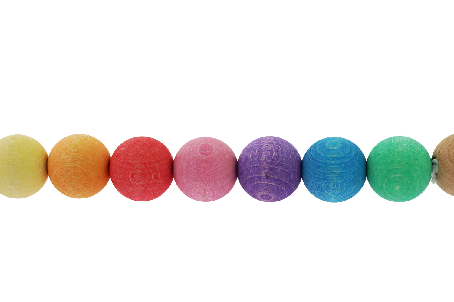 Close up of the balls on the Nic Rainbow Wooden Pram Chain pictured on a plain background