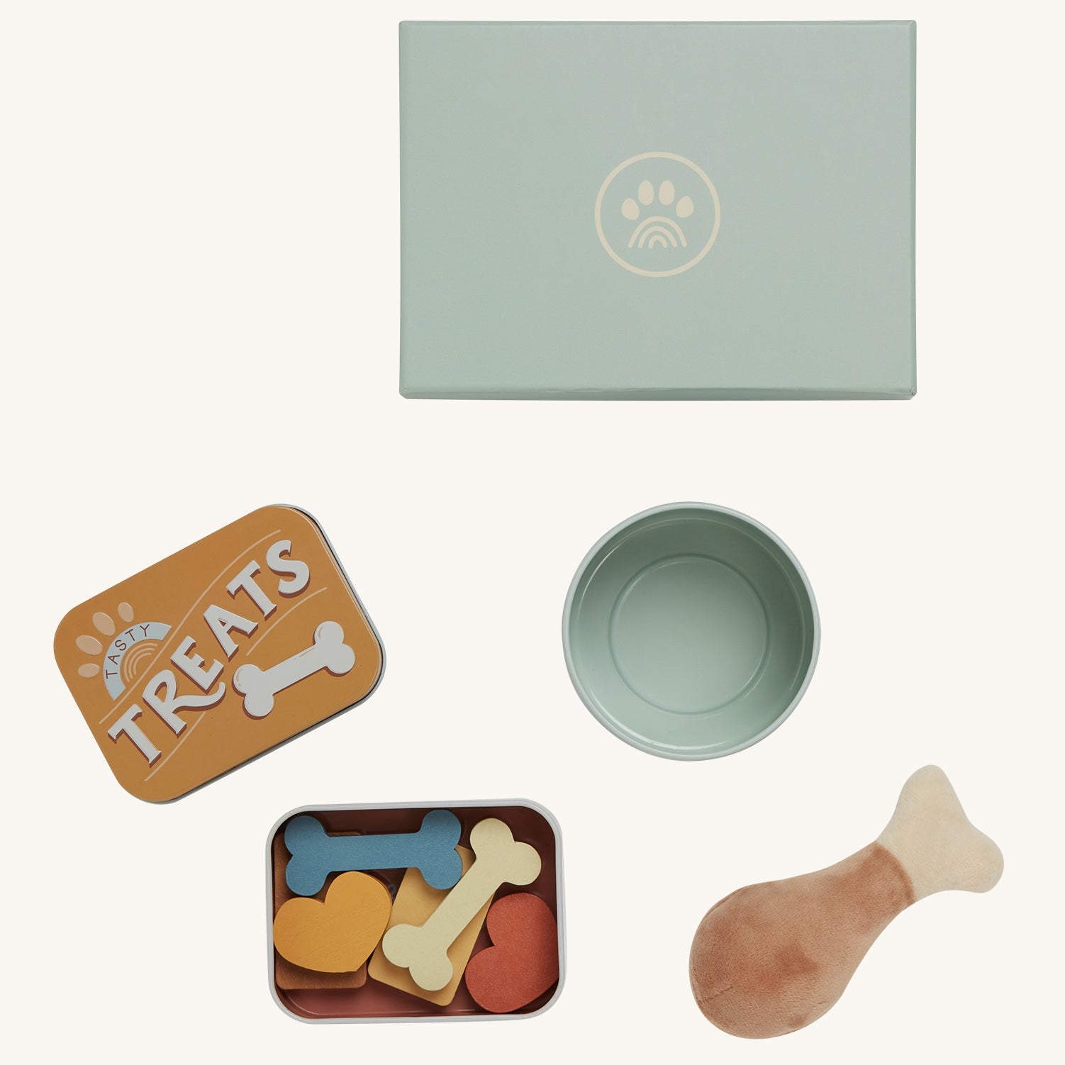 The Olli Ella Dinkum Dog Goodies Set is a set of play toys that can be used as accessories for your Dinkum Dog. This set contains a box with a small tin reading "Treats"