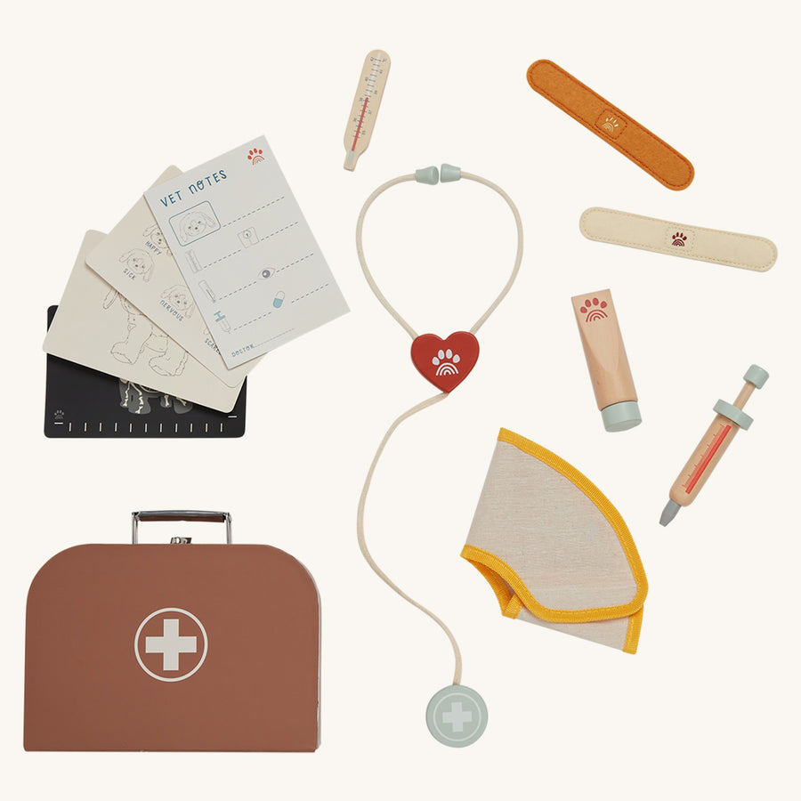 The Olli Ella Dinkum Dog Vet Set is a brown Vet's bag containing a toy stethoscope