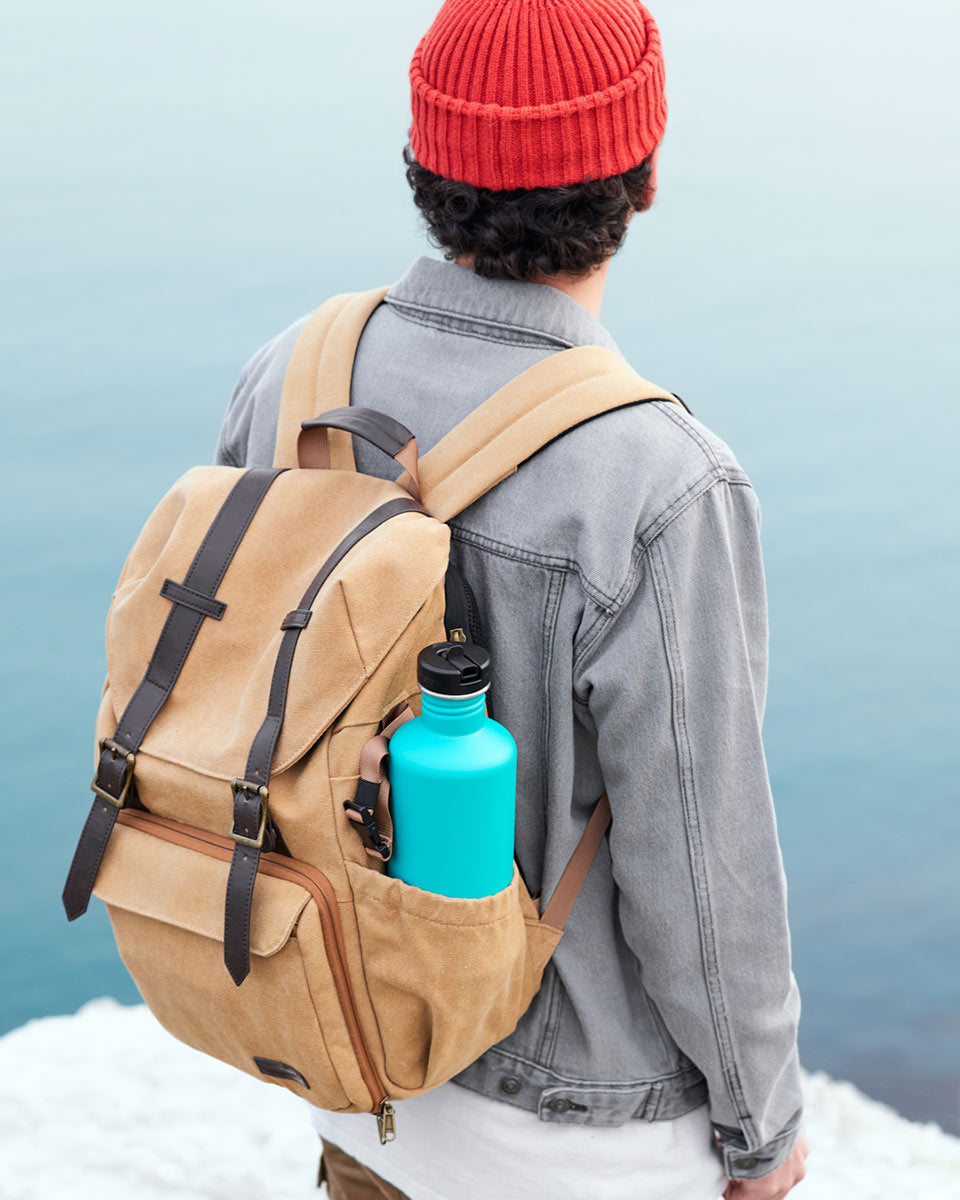 Man wearing a rucksack with a One Green Bottle 800ml metal water bottle in the side pocket