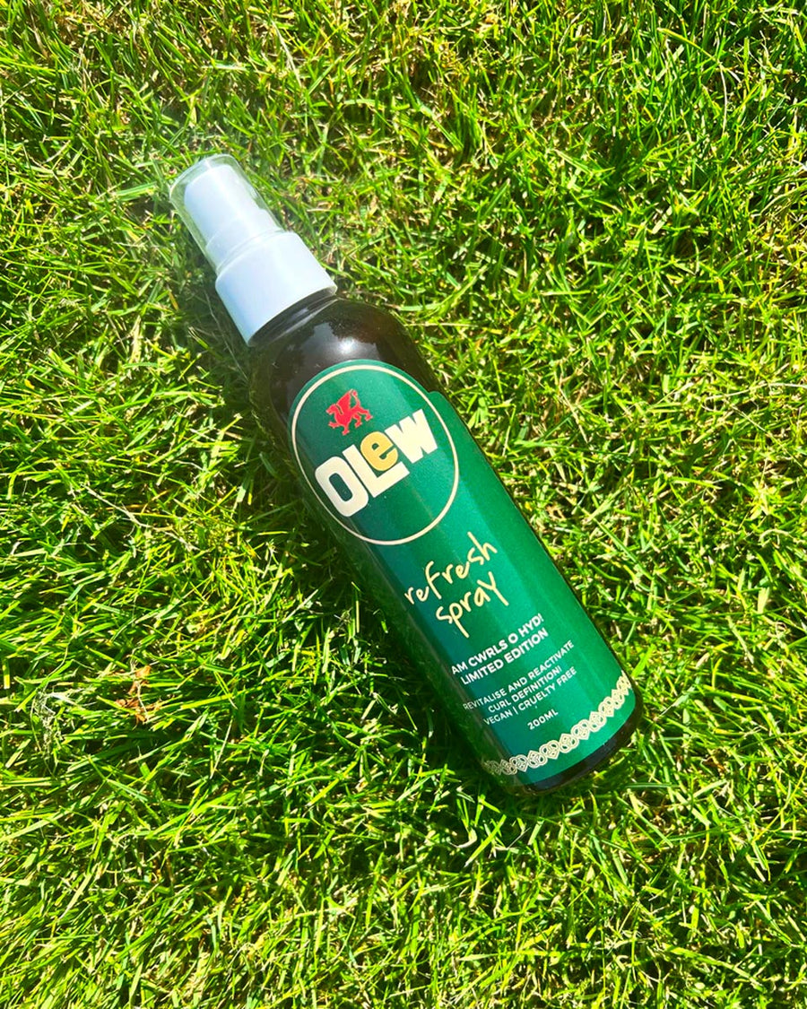 Olew limited edition natural hair refresh spray on some green grass