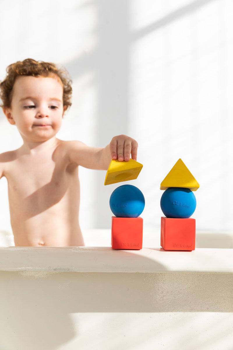 Child stacking the Oli & Carol X Bauhaus Movement Floating Geometric Blocks