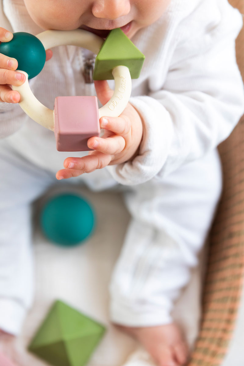 Baby chewing on the Oli & Carol X Bauhaus Movement Teething Ring in Pastel Colours