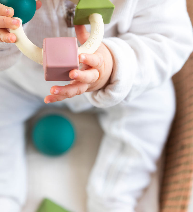 Baby chewing on the Oli & Carol X Bauhaus Movement Teething Ring in Pastel Colours