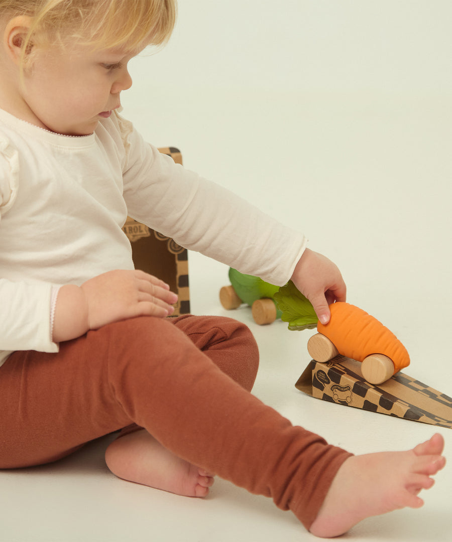 A child playing with the Oli Carol Rubber Cars