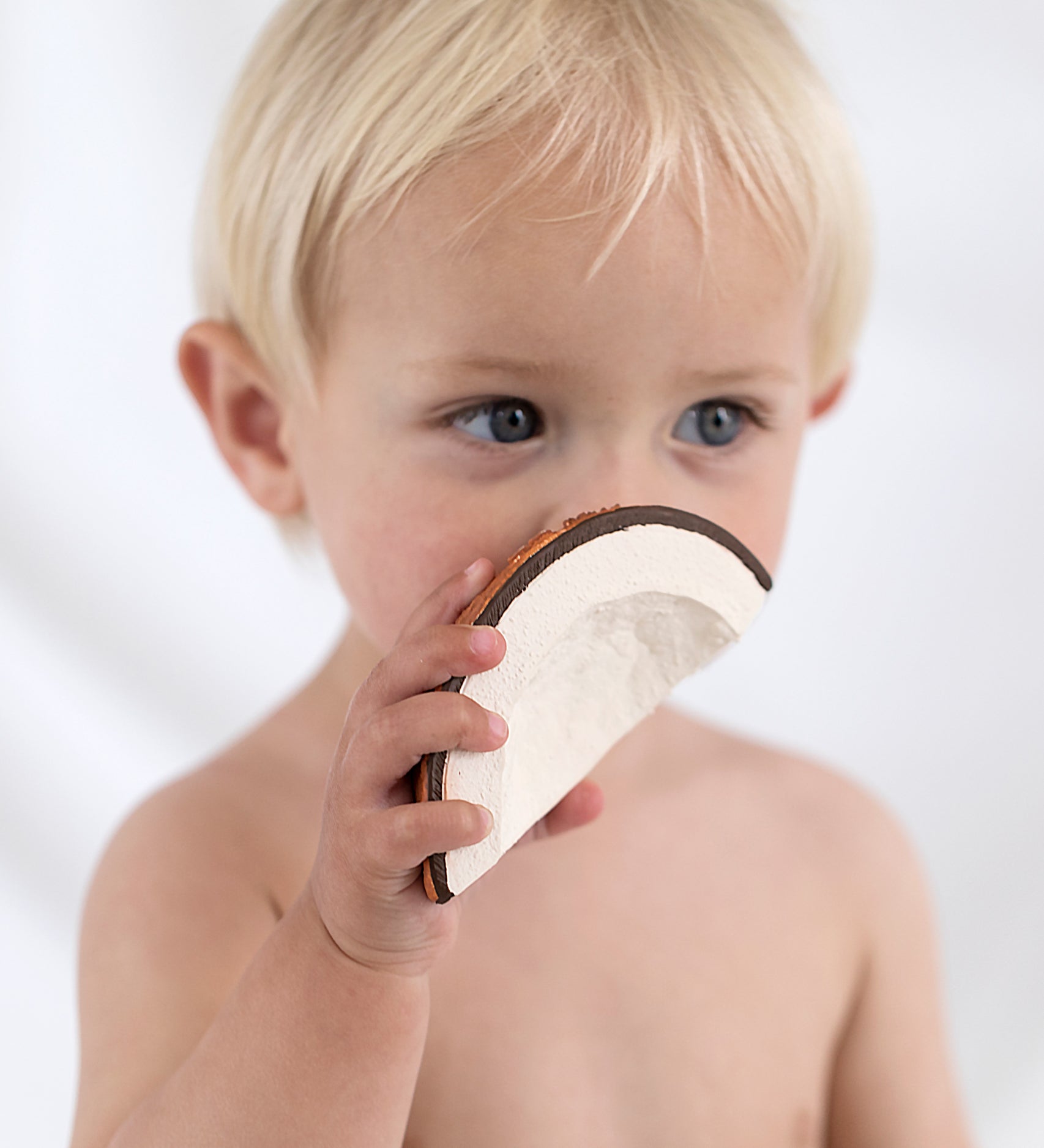 A child holding the Oli & Carol Coco The Coconut. 