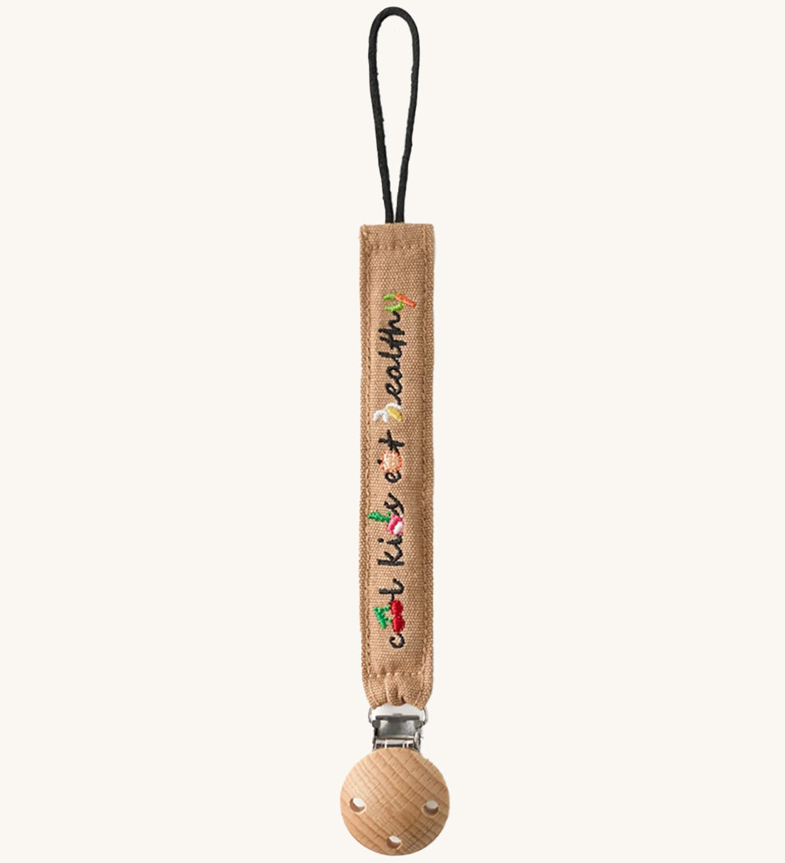 Oli & Carol Cool Kids Pacifier Clip, the words cool kids eat healthy written on a beige canvas with vegetable embroidery detail