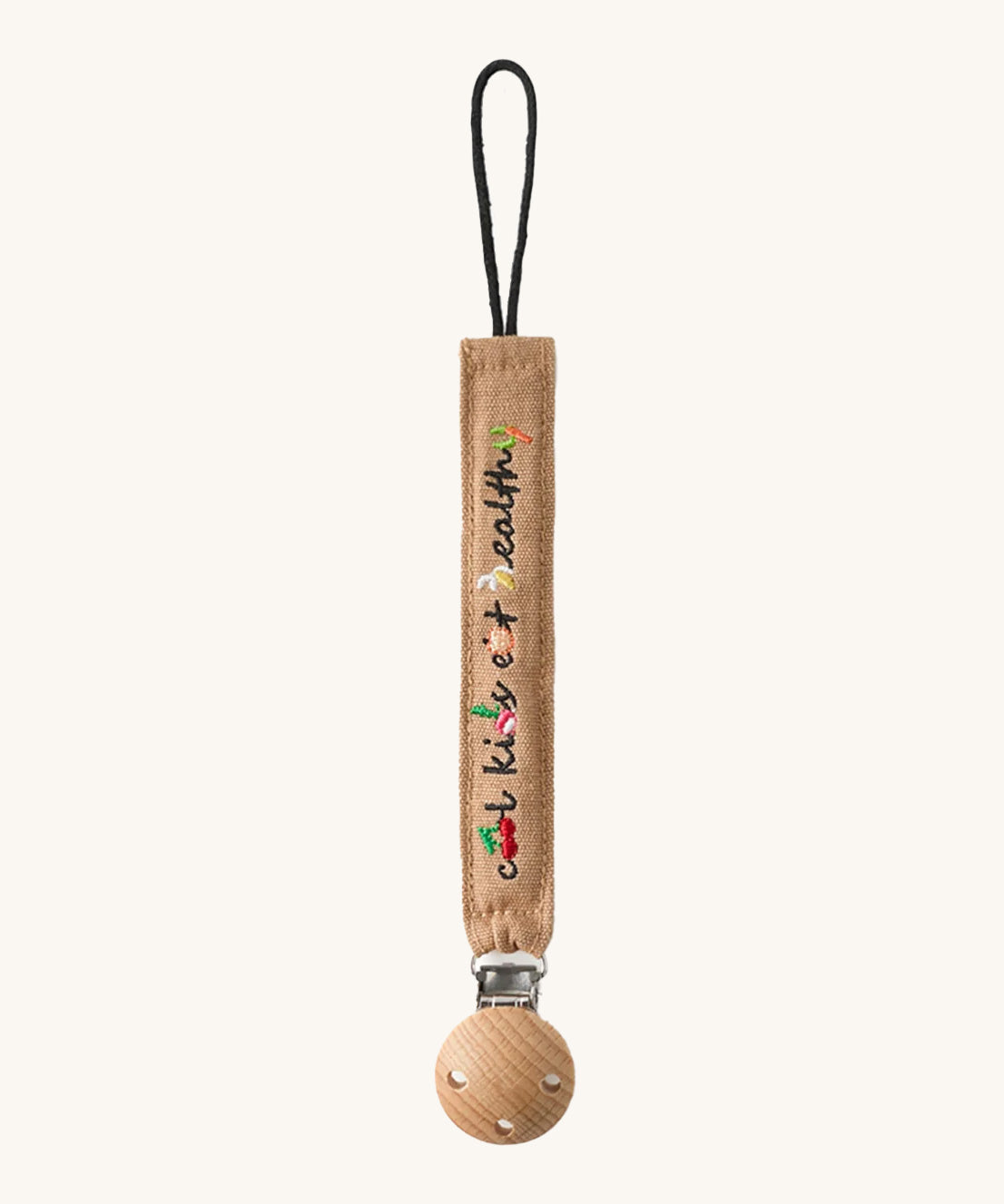 Oli & Carol Cool Kids Pacifier Clip, the words cool kids eat healthy written on a beige canvas with vegetable embroidery detail