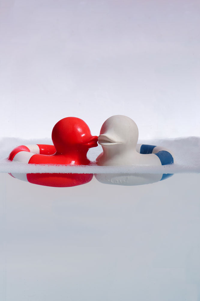 Oli & Carol red and whiet and blue Flo The Floatie Ducks in water