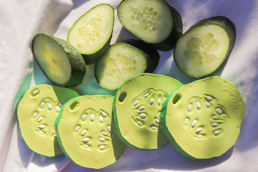 Oli & Carol Pepino The Cucumber natural rubber toys pictured next to slices of real cucumber