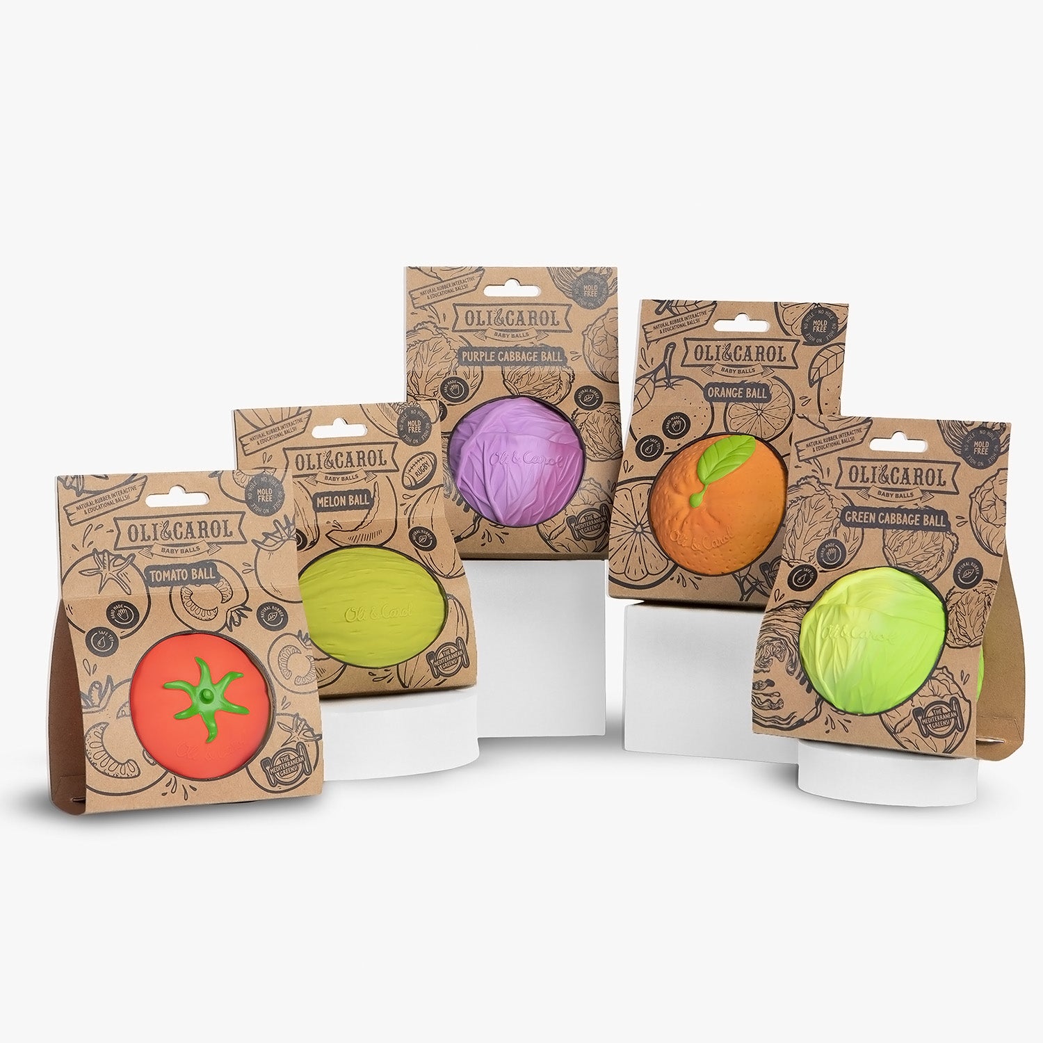 Five fruit and vegetable Oli & Carol 100% Natural Rubber Baby Sensory Balls in their cardboard packaging on a white background