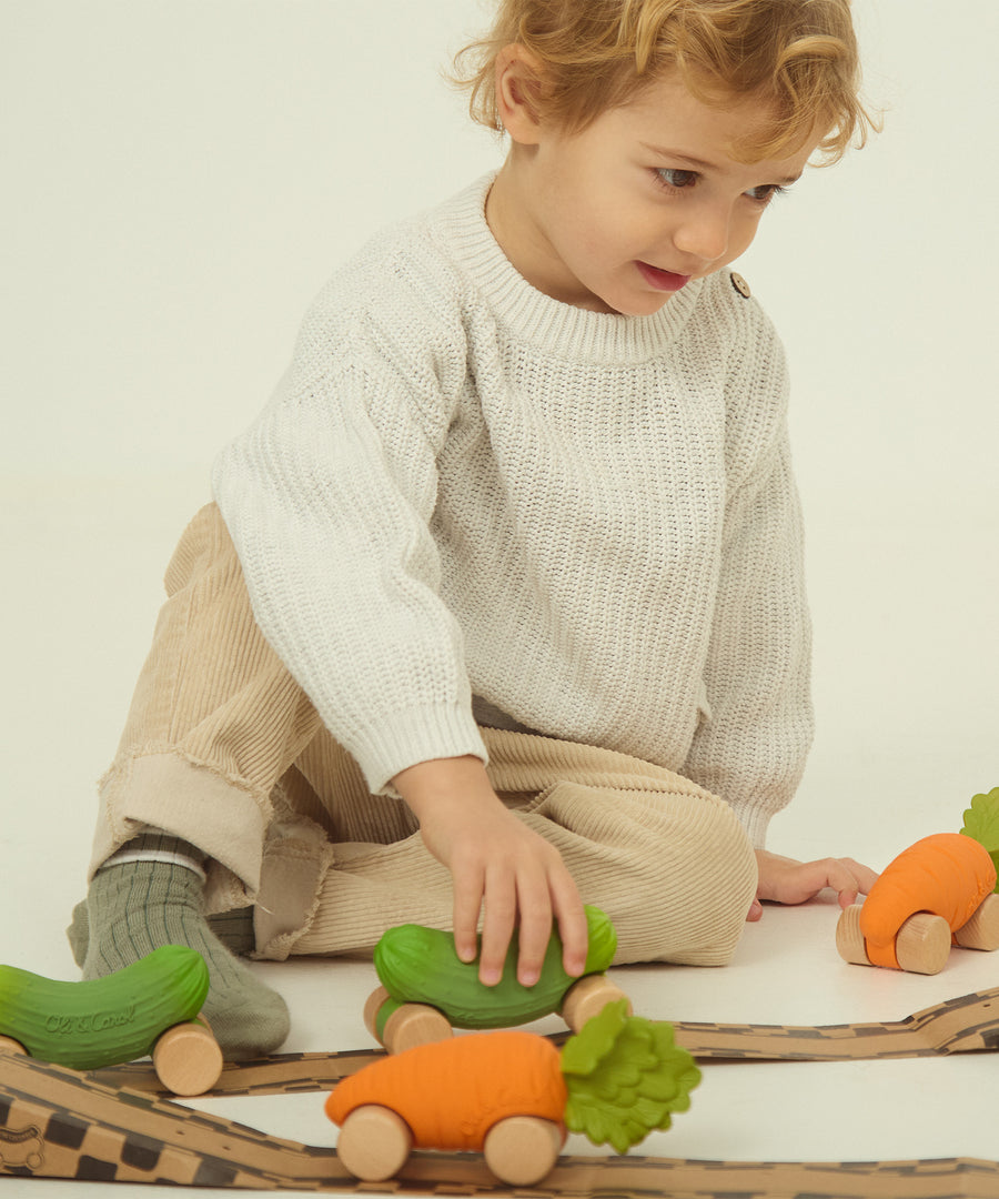 A different angle showing the Oli & Carol Cathy The Carrot Baby Car. A fun orange carrot car with a green leafy top