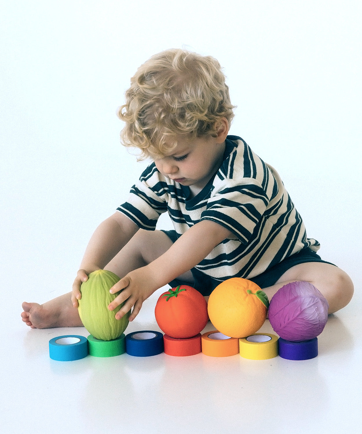 Toddler colour-matching with different fruit and vegetable Oli & Carol 100% Natural Rubber Baby Sensory Balls