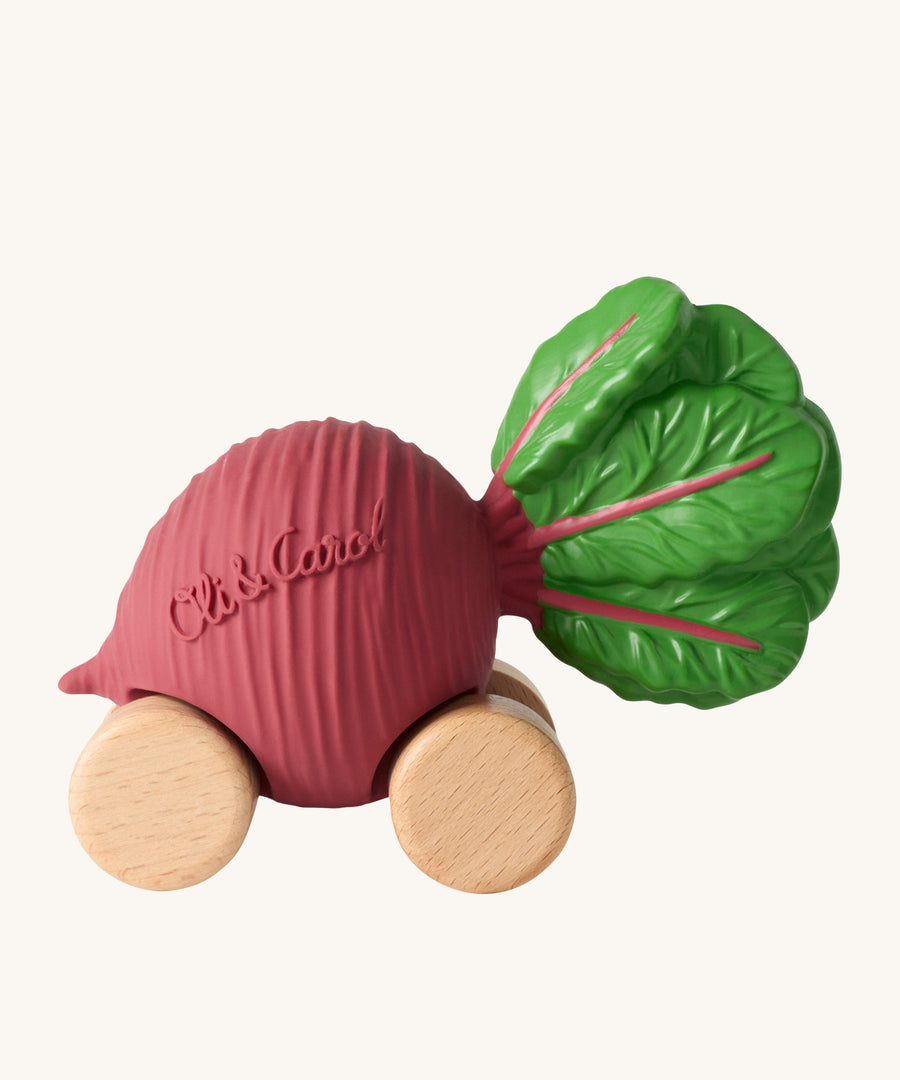 Oli & Carol Betty The Beetroot Baby Car. A fun purple beetroot car with a green leafy top, and wooden wheels on a cream background