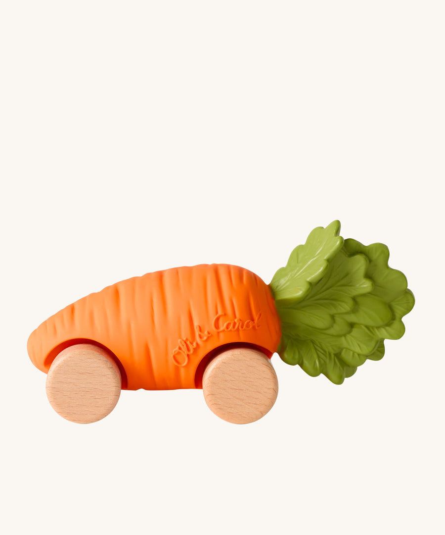 Oli & Carol Cathy The Carrot Baby Car. A fun orange carrot car with a green leafy top, and wooden wheels on a cream background