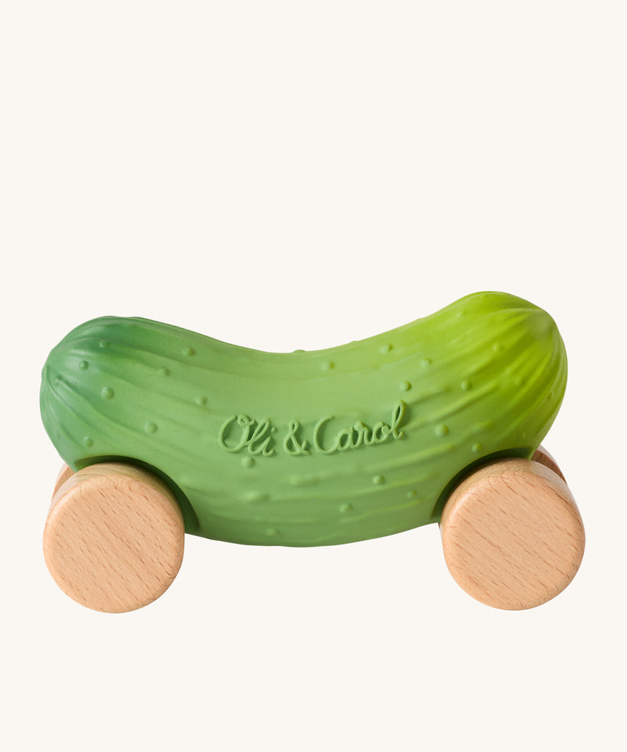 Oli & Carol Pepino The Pickle Baby Car. A fun green pickle car with a with wooden wheels on a cream background