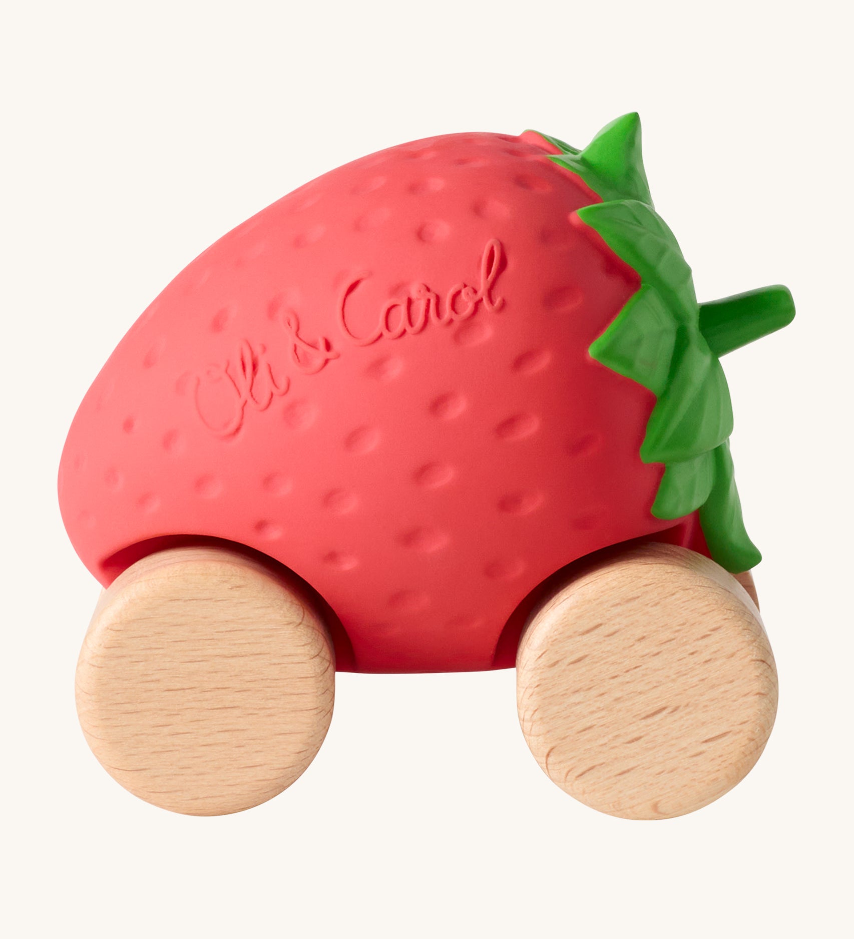 Oli & Carol Sweetie The Strawberry Baby Car. A fun red strawberry car with a green leafy top, and wooden wheels on a cream background