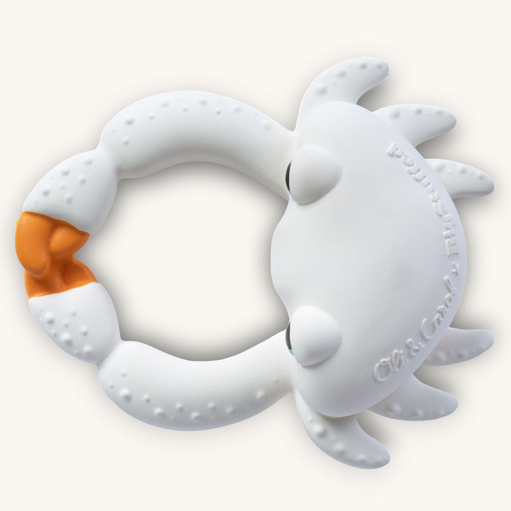 Picture of a baby teething on the Oli and Carol Sharon the Crab rubber bath toy.