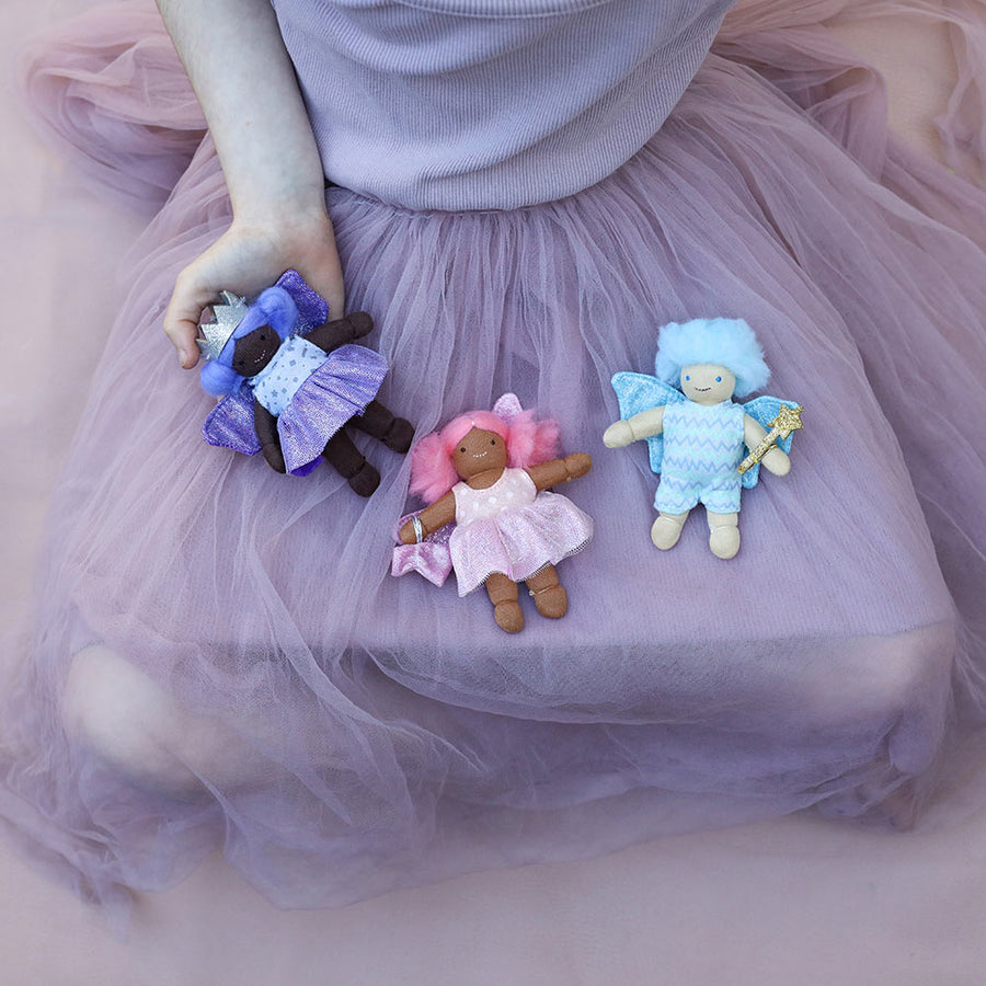 Olli Ella Holdie Birthday Fairy Doll - Bluebell - held by a child blowing out a birthday cucake